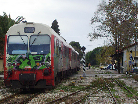 The-engine-of-a-Hellenic-Railways-Organization-train-covered-with-a-vividly-colored.png